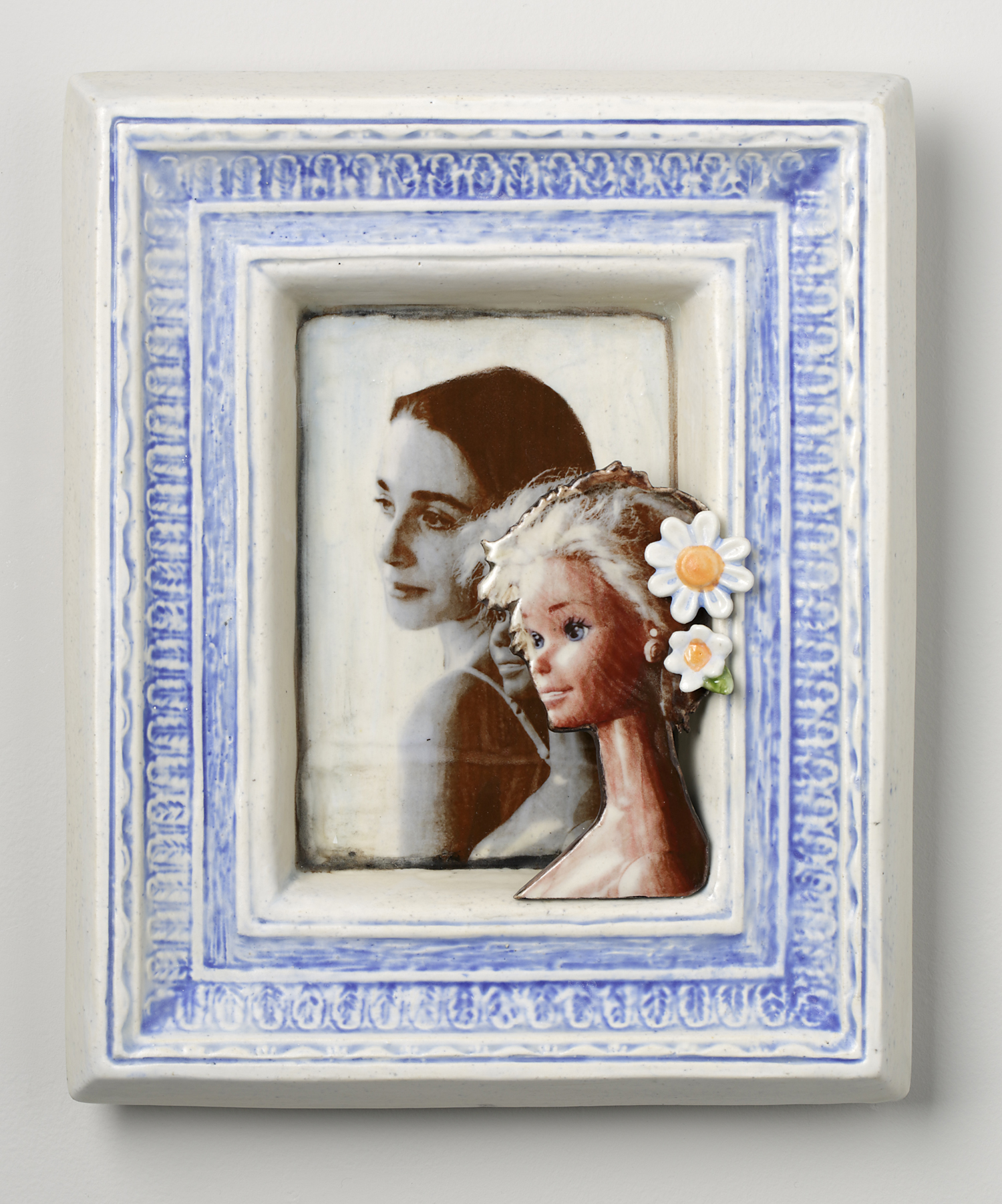 Portraits of girl and barbie in ceramic blue and white frame