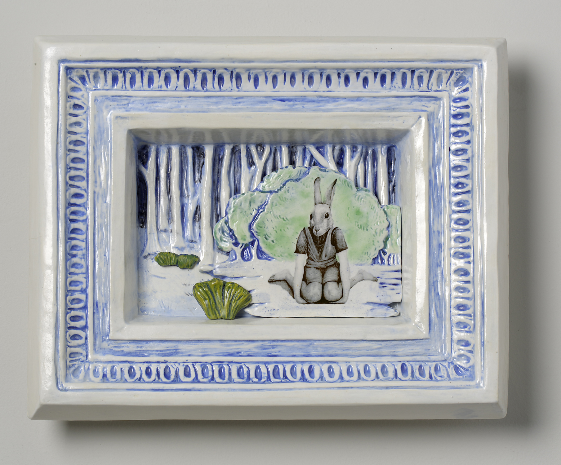 Rabbit headed girl sitting in front of trees and bushes, relief and decals in ceramics