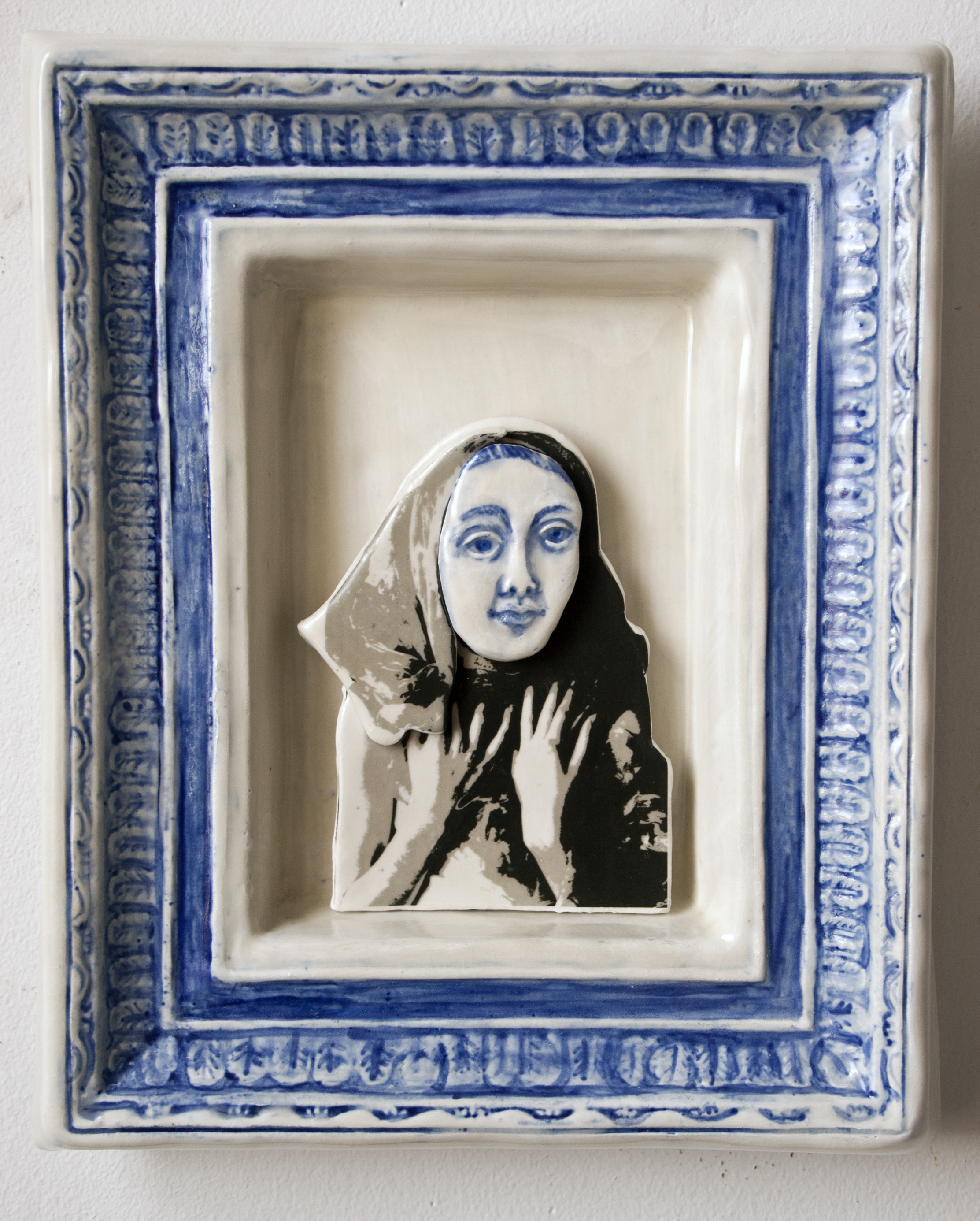 photo decal of girl, upper body only, with kerchief, hands held in front of chest, face in relief